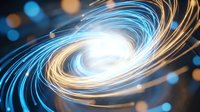 Abstract swirling light trails in blue and gold creating dynamic spiral motion with glowing bokeh background for modern digital design projects.
