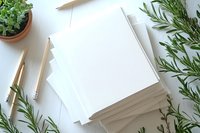 Blank white paper sheets with natural rosemary herbs and wooden pencils on desk for creative writing, planning or organic design projects.