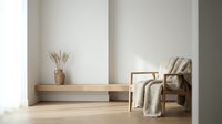Minimalist modern living room interior with wooden furniture, neutral beige armchair, decorative vase with dried branches, and warm natural lighting.