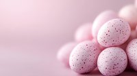 Speckled pink candy eggs with delicate red dots arranged in soft composition against blurred pastel background, creating dreamy Easter holiday atmosphere.