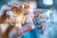 Protective eyewear with sparkling glitter and bokeh effects against blurred background creates magical science laboratory atmosphere.