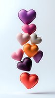 Colorful heart-shaped macarons floating in vertical arrangement on white background. Sweet French pastries in purple, pink, orange, red tones for romantic designs.