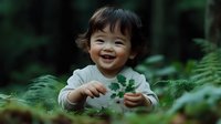 Joyful Asian toddler exploring nature, holding green leaves while playing outdoors among ferns in forest setting, genuine candid expression of childhood wonder and discovery.