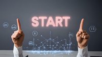 Professional hands pointing upward at glowing neon start text with futuristic network visualization and business icons floating against dark background. Modern business concept.