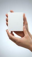 Hands holding blank white cube against gray background for product presentation, mockup design, branding and creative projects.