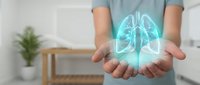 Healthcare professional displaying holographic lung anatomy model in cupped hands for medical education and respiratory system visualization.