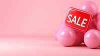 Pink glossy spheres with red sale sign on pastel pink background, minimal retail marketing composition for promotional design and advertising campaigns.