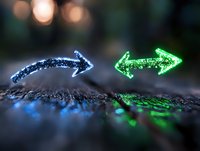 Glowing blue and green arrows pointing in opposite directions on dark textured surface with bokeh background, symbolizing choice, direction and decision making.