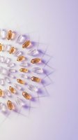 Vitamin capsules scattered on purple gradient background with soft shadows creating modern healthcare and wellness concept for medical design.