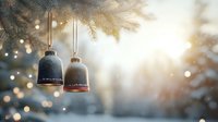 Rustic ceramic bells hanging on Christmas tree with magical bokeh lights and snowy pine branches in soft winter sunlight. Festive holiday atmosphere.