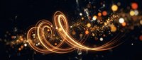 Golden light trails creating elegant swirls and curves with sparkling particles and bokeh effects on dark background for luxury design projects.