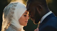 Muslim bride and groom in intimate moment during wedding ceremony with golden sunset lighting creating romantic atmosphere for marriage celebration.
