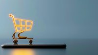 Glowing neon shopping cart icon on smartphone edge against blue background, representing mobile commerce and online shopping technology.