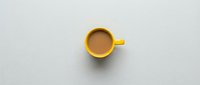Yellow coffee mug with brown beverage on clean white background, isolated for design projects and commercial use in cafes and restaurants.