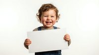 Happy toddler boy with curly brown hair holding blank white paper sign on isolated background for custom text and design projects.