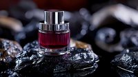 Luxury red perfume bottle on dark volcanic rocks with elegant bokeh lighting for premium fragrance and cosmetics advertising campaigns.