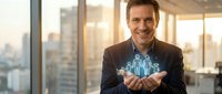 Confident businessman holding holographic city model in modern office with urban skyline view during golden hour sunset lighting for corporate presentations.