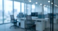 Blurred modern office interior with glass walls and conference room furniture creating professional corporate workspace atmosphere for business presentations.