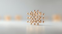 Metallic rose gold molecular structure model on light background with soft focus and reflection, showing scientific atomic bonds and symmetry.
