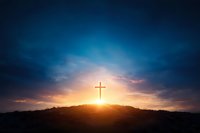 Glowing Christian cross silhouette on hill at sunset with dramatic sky and sunbeams breaking through dark clouds, spiritual background for religious themes.