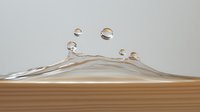 Macro photography of water splash crown formation with droplets floating above rippled liquid surface against neutral background, capturing fluid dynamics.