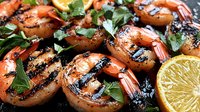 Grilled jumbo shrimp with charred marks, fresh herbs and citrus slices on dark background, close up view showing juicy texture and seasoning details.