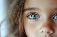 Close up macro shot of bright blue eyes with long eyelashes and soft skin texture, artistic portrait photography with shallow depth of field and dreamy bokeh effect.
