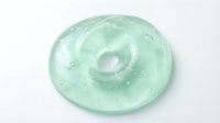 Transparent gel disc with swirling texture and water droplets on white background, isolated for skincare and cosmetic product design use.