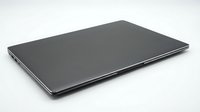 Sleek closed laptop with dark metallic lid on white background, isolated for tech, business, and digital lifestyle concepts.