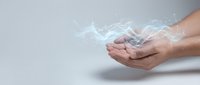 Hands holding glowing digital energy with light effects and particles on neutral background for technology and innovation concepts.