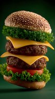 Double cheeseburger with fresh lettuce, tomato slices, and beef patties on sesame seed bun against dark green background, macro food photography.