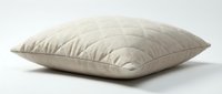 Soft beige quilted pillow with diamond stitching pattern on white background, isolated for bedding, home decor, and interior design projects.