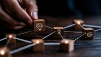 Connected wooden cubes with glowing light bulb icons forming network pattern on dark surface, illustrating business innovation and interconnected ideas concept.