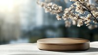 Wooden round platform with spring cherry blossoms and soft sunlight creating natural product display background for cosmetics and branding.