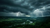 Dramatic thunderstorm with lightning bolts striking over lush green valley and winding river during heavy rainfall and dark cloud cover.