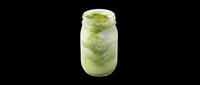 Refreshing green matcha latte beverage in clear glass jar with ice cubes and powder topping, isolated on transparent background ready for t-shirt designs, clipart, stickers, and print-on-demand products.