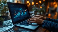 Young Asian woman analyzing financial market data on laptop with glowing blue charts and graphs against evening bokeh lights background.