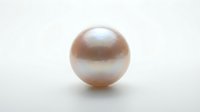 Lustrous pearl sphere with soft peachy-pink iridescent finish isolated on white background, suitable for jewelry, luxury, cosmetics, and design projects.