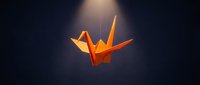 Orange origami paper crane suspended against dark background with dramatic lighting creating peaceful zen atmosphere for meditation and mindfulness concepts.