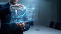 Professional businessman in dark suit presenting holographic financial data dashboard with glowing charts and analytics in modern office environment.