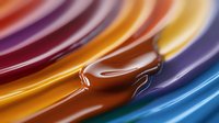 Abstract liquid chocolate swirl with vibrant rainbow colors flowing in smooth waves creating dynamic motion for food and beverage design backgrounds.
