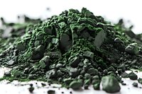 Macro shot of crushed green spirulina powder scattered on white surface, showing detailed texture and natural organic pigment for healthy superfood concept.