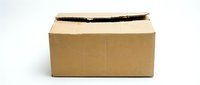 Damaged brown cardboard shipping box with torn black tape on white background isolated for packaging and delivery concepts.