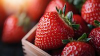 Fresh ripe strawberries with green leaves in wooden box, macro shot showing detailed texture and natural juicy appearance. Organic healthy fruit concept.
