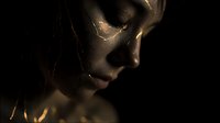 Dramatic portrait of young woman with golden light patterns on face against dark background creating mysterious atmospheric mood for creative projects.