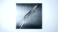 Scratched brushed metal surface with diagonal claw marks creating industrial texture for modern design projects and metallic backgrounds.