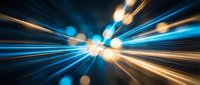 Dynamic light trails and bokeh effects creating radial motion blur with bright golden and blue streaks radiating from center point on dark background.