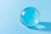 Transparent glass sphere or crystal ball with light refraction on pastel blue background casting soft shadow, minimalist composition for design projects.