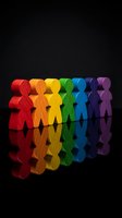 Colorful wooden figures standing in rainbow formation on reflective black surface representing diversity, teamwork and unity in business concepts.
