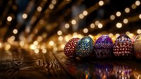 Colorful handcrafted Easter eggs with intricate dot patterns arranged in row on wooden surface against blurred warm bokeh lights background creating festive atmosphere.